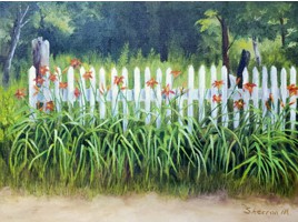 Lilies against a fence, along a road